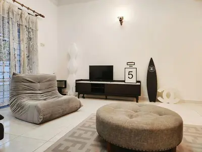 a living room with a couch and a chair and a tv at 5 min to ipoh town pasir puteh 5br 22pax in Ipoh