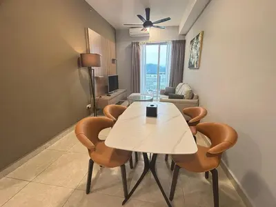 a living room with a white table and chairs at Wyndham Garden Suites IPOH ICC in Ipoh