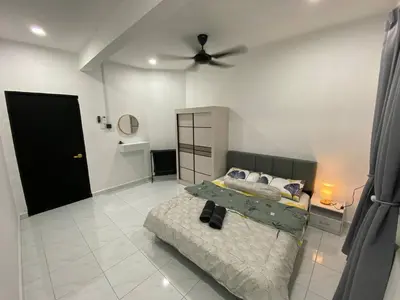 a bedroom with a bed and a ceiling fan at Rania Homestay Tasek Gelugor in Padang Chempedak