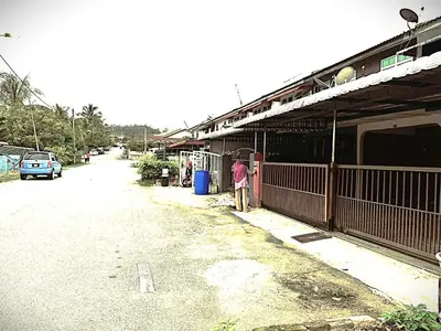 a person standing on a street next to a building at D' Gerik Homestay Taman Sinaran in Gerik