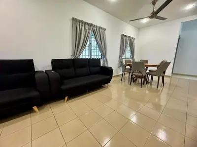 a living room with a couch and a table and chairs at Cozy Stay ALMA NearAEON\u5927\u5c71\u811a\u6e29\u99a8\u6c11\u5bbf in Bukit Mertajam