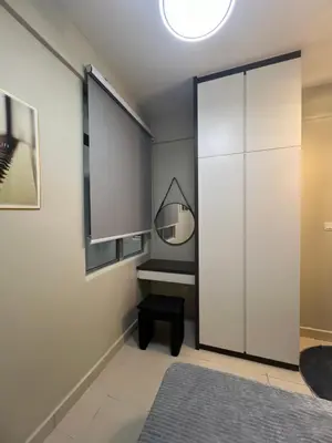 a bedroom with a large white closet and a mirror at SweetHome in Ipoh