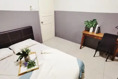 a bedroom with a bed with a table and a desk at Kinta Riverfront Apartment Ipoh, Fully Air-Con Suite IPOH in Ipoh