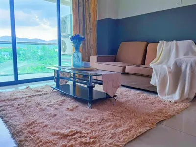 a living room with a couch and a table at Kinta Riverfront Apartment Ipoh, Fully Air-Con Suite IPOH in Ipoh