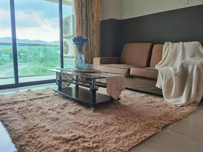 a living room with a couch and a glass table at Kinta Riverfront Apartment Ipoh, Fully Air-Con Suite IPOH in Ipoh