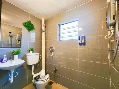 a bathroom with a toilet and a sink at Ipoh 168 Taman Pelangi, Persiaran Halaman Ampang Ipoh Homestay in Ipoh
