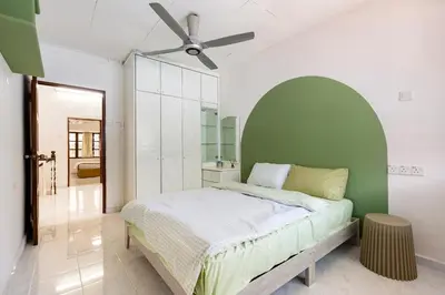a bedroom with a bed and a ceiling fan at Riverview Staycation 5mins to Sunway Carnival for 9 pax in Perai
