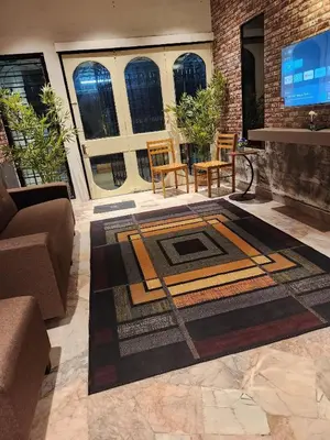 a living room with a couch and a rug at Sun Rock Home by Ipoh Maju Stay in Ipoh