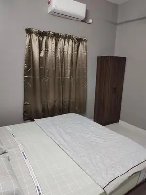 a bed in a room with a window with a curtain at DeStay Taiping in Taiping