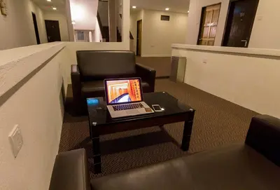 a laptop computer sitting on a coffee table in an office at HOTEL RAUB since 1968 in Raub