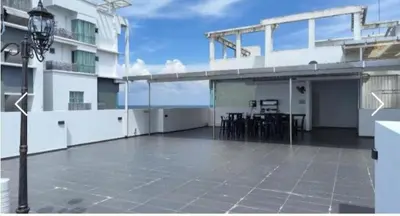 a large balcony of a building with a table and chairs at Sekinchan SeaView Garden 20pax 6R6B HighView in Sekincan