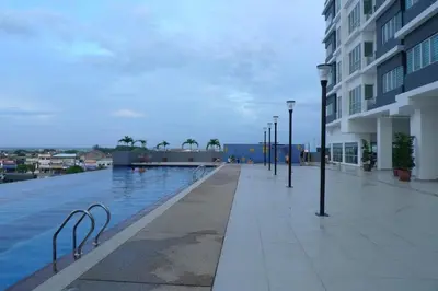 a swimming pool with lights next to a building at Sekinchan SeaView Garden 20pax 6R6B HighView in Sekincan
