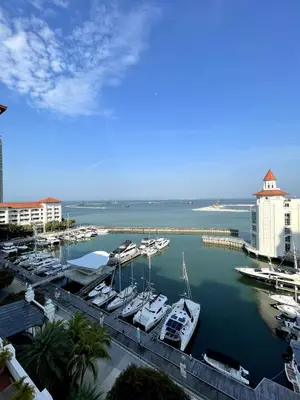 a marina with boats docked in the water at Marina Suite with Seafront Sunrise View in George Town