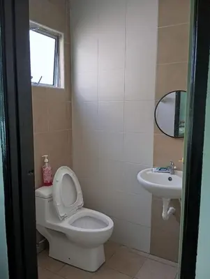 a bathroom with a toilet and a sink at Jwa Vacastay in Lumut