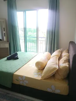 a bedroom with a bed with pillows and a window at Jwa Vacastay in Lumut