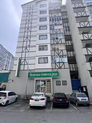 a large building with cars parked in a parking lot at AYAAN BLOOM BUDGET HOMESTAY FREE WiFi & Netflix in Cameron Highlands