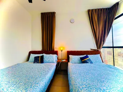 a bedroom with two beds and a window at Premium 5 queen bed luxury 2BR suites infinity pool netlfix in Jelutong