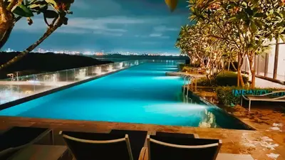 a view of a river from a resort at night at Premium 5 queen bed luxury 2BR suites infinity pool netlfix in Jelutong