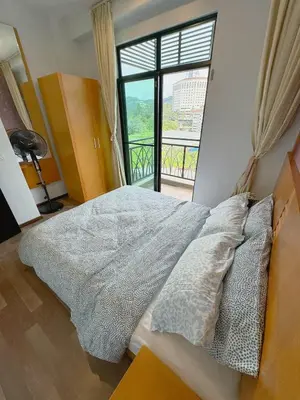 a bedroom with a bed and a large window at Sunrise & KeaFarmview at Hilltop NOVA CoolSummer in Tanah Rata