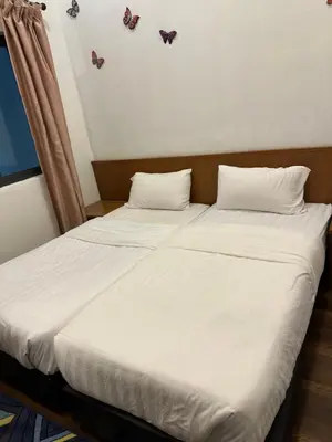two beds in a room with butterflies on the wall at Nova Highlands Hilltop Retreat Cameron Highlands in Brinchang