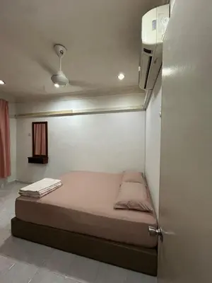 a small bedroom with a bed in a room at Double Storey Terrace House in Perai