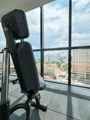 a chair in an office with a view of a city at Panoramic Georgetown City & Sea View with Netflix in Jelutong