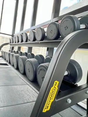 a row of dumbbells on a rack in a gym at Panoramic Georgetown City & Sea View with Netflix in Jelutong