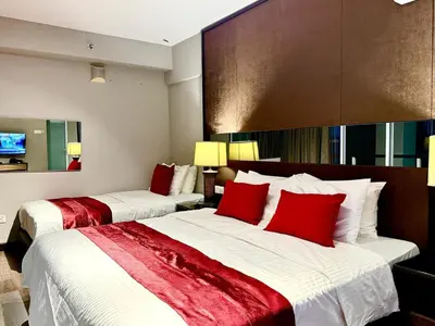 two beds in a hotel room with red pillows at Seaview Seafront Duplex in Town with WiFi & Full Kitchen 10 in George Town