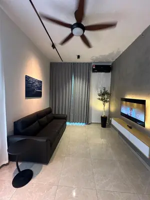 a living room with a couch and a ceiling fan at ICC Luxury Suites Ipoh City Centre By Landmark in Ipoh