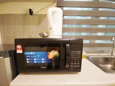 a microwave with a food on top of it at D'Ocean Marina Laguna Resort by Manhattan Group in Lumut