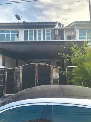 a car parked in front of a house with a fence at Budget Homestay Lahat in Ipoh