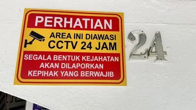a sign on the side of a building that reads perritain area in driveway at Raintown House in Taiping