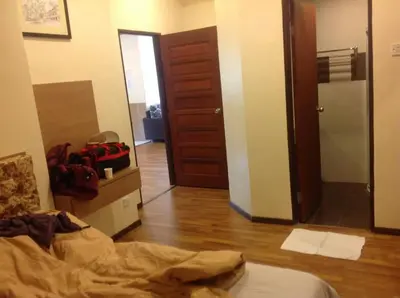 a bedroom with a bed and a hallway with a door at Golf View Apartment in Brinchang in Tanah Rata