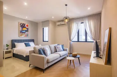 a living room with a bed and a couch and a tv at Iconic Regency by Stellar ALV in Bayan Lepas