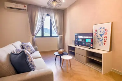 a living room with a couch and a tv at Iconic Regency by Stellar ALV in Bayan Lepas
