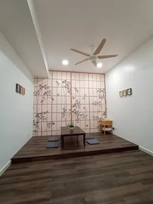 a room with a ceiling fan and a table at Cheerfull-Cozy Japanese Style in Bukit Mertajam