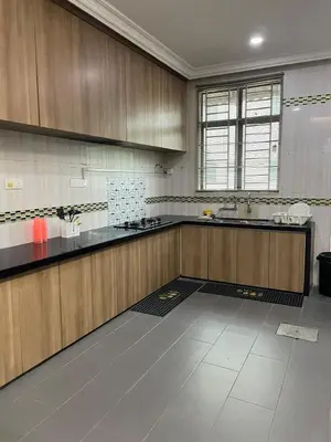 a large kitchen with wooden cabinets and a sink at 6 Rooms Budget 3 Tingkat USM Gelugor Georgetown in Gelugor