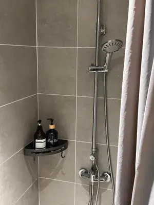 a shower with a shower head in a bathroom at IPOH City Centre ICC Suites by HWC in Ipoh