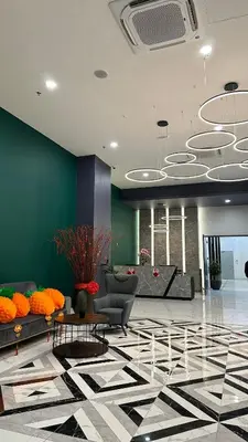 a lobby with a couch and a table at IPOH City Centre ICC Suites by HWC in Ipoh