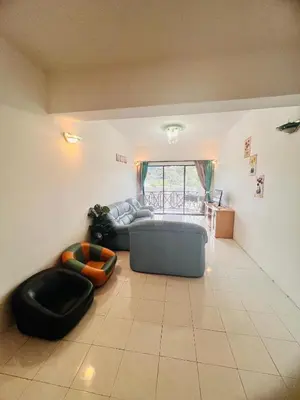 a living room with a couch and a chair at Rayyan'Homestay PARKVIEW in Tanah Rata