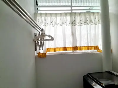 a window in a kitchen with a white curtain at Zayyan Homestay Parit Buntar in Parit Buntar