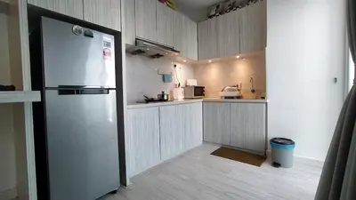 a kitchen with a refrigerator and a counter top at Mansion One 279 in George Town