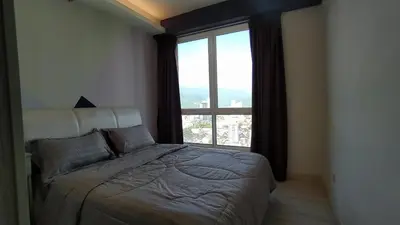 a bedroom with a bed and a large window at Mansion One 279 in George Town