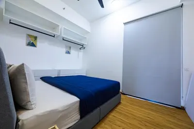 a bedroom with a bed with a blue blanket at Beacon Suites #Georgetown #FamilyStay #13A #Cozy in George Town