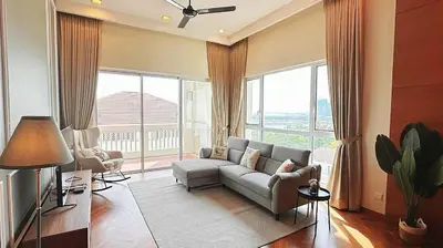 a living room with a couch and a large window at Straits Quay Highest & Spacious Seaview Suite - 3 in Bagan Jermal