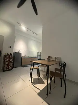 a table and chairs in a room with a kitchen at horizon ipoh in Ipoh