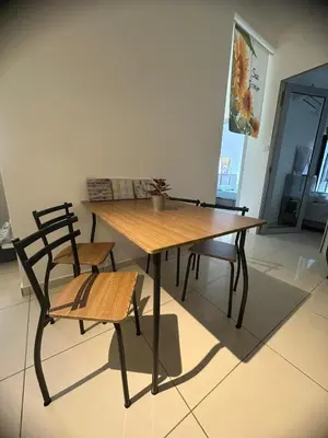a wooden table and two chairs and a table and bench at horizon ipoh in Ipoh