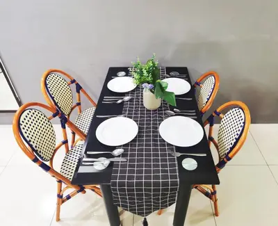 a black table with chairs and a plant on it at Ipoh Kinta Riverfront Air-Con Cozy Home in Ipoh