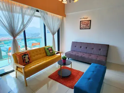 a living room with a couch and a table at Ipoh Kinta Riverfront Air-Con Cozy Home in Ipoh