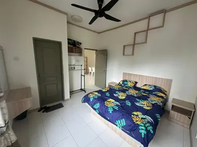 a bedroom with a bed and a ceiling fan at Family Stay at Quintet A3A-3A-6 in Tanah Rata